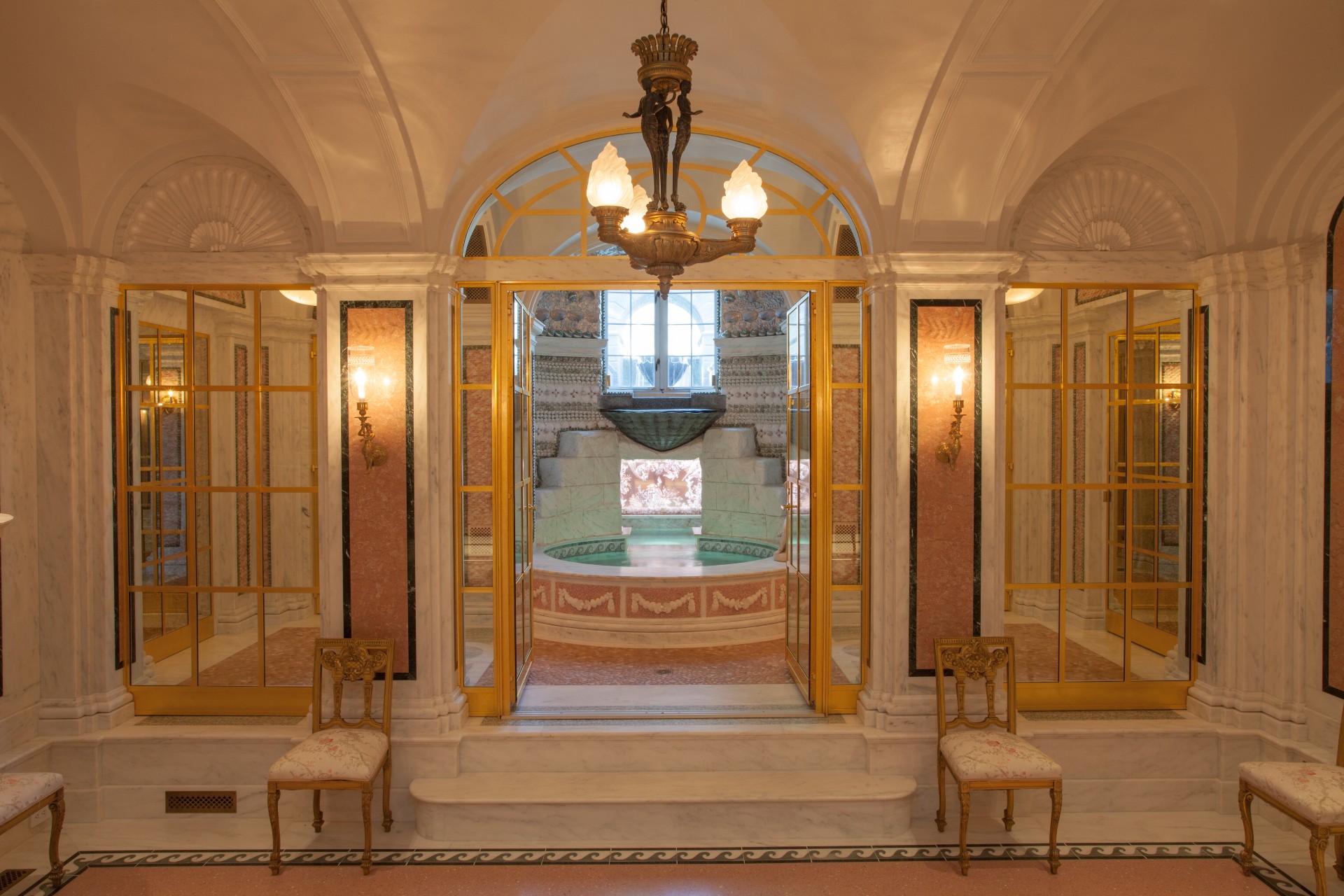 Ornate vaulted interior at Bellevue House, with marble walls and a central fountain.