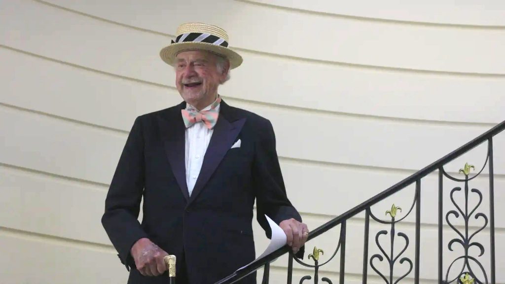 Mr. Fleming wearing a straw hat on the steps of Bellevue House during the Summer Solstice Musicale.